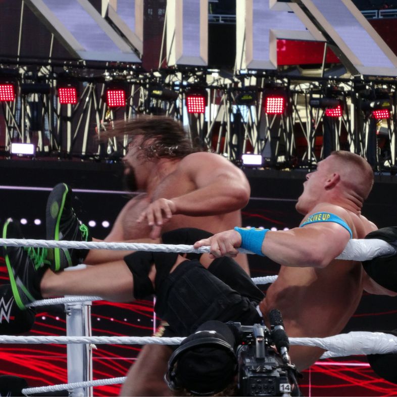 WWE wrestler John Cena kicks Rusev in the face in the corner of the ring during United States Championship title wrestling match at Wrestlemania 31 stadium