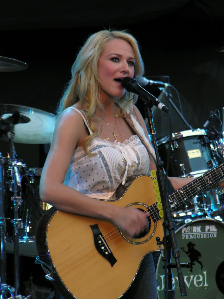 This is an image of Jewel performing in concert. Jewel is a popular musician from the United States