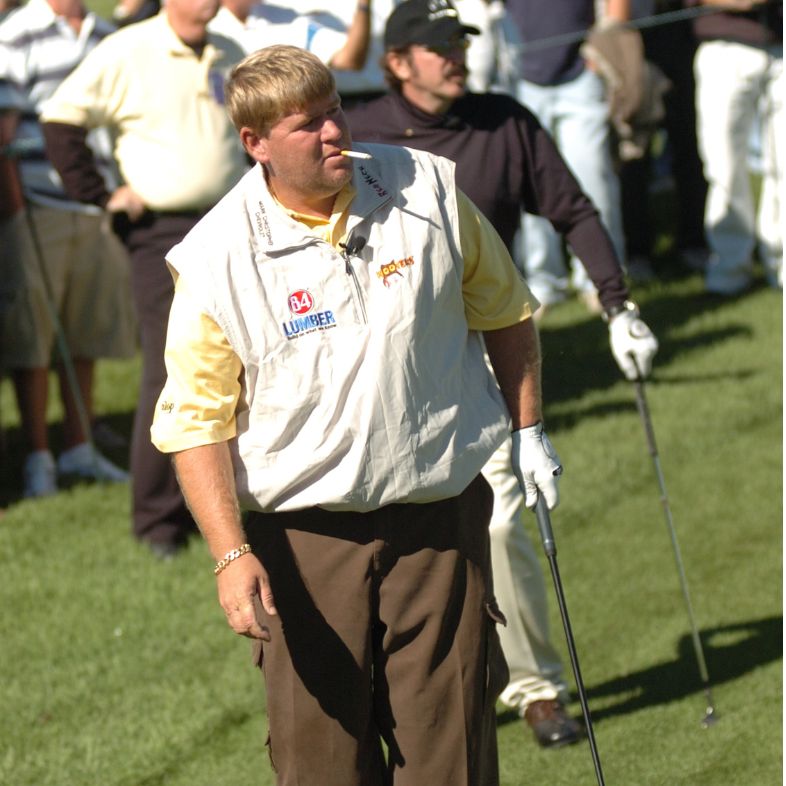 John Daly watches one of his approach shots headed for the green. In this picture you can see Daly with a cigarette hanging out of his mouth.
