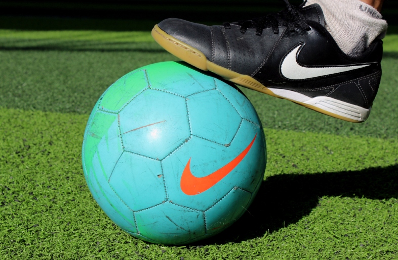 Closeup view of Football and a Shoe of Nike brand