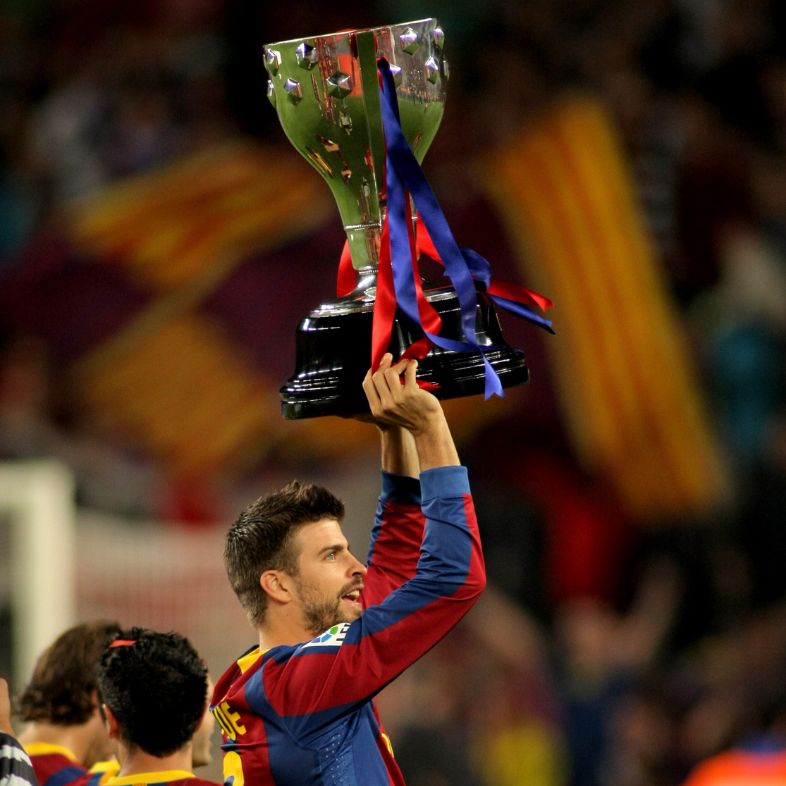Gerard Pique of Barcelona celebrates holds up the trophy league at Nou Camp Stadium in Barcelona, Spain May 15, 2011