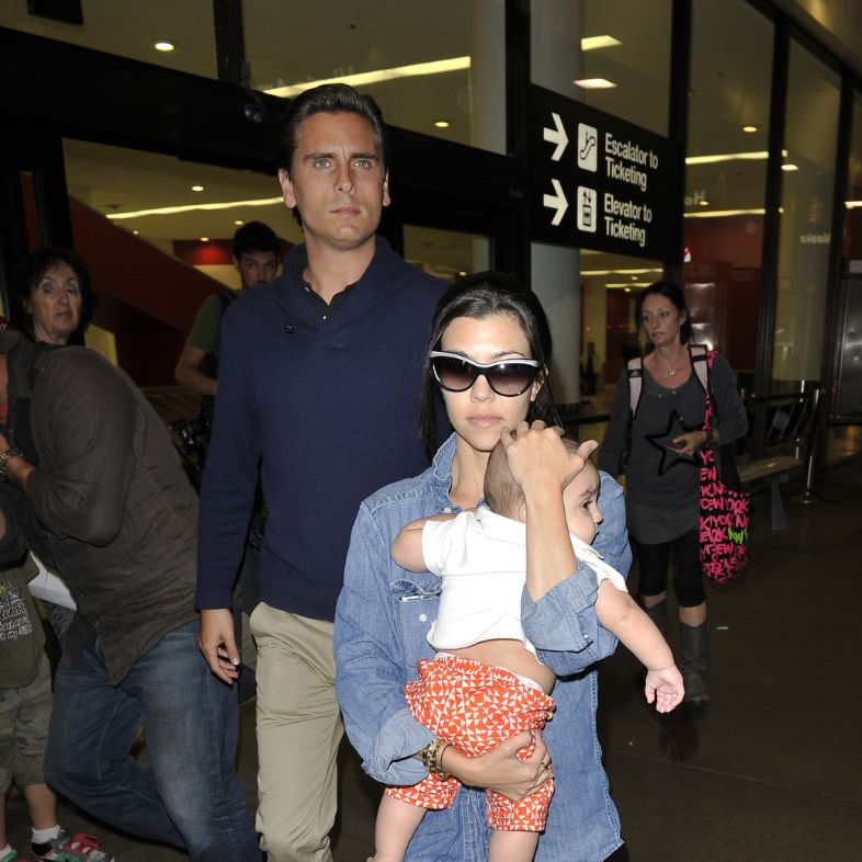 LOS ANGELES-JULY 5: Kourtney Kardashian with baby and husband Scott Disick at LAX