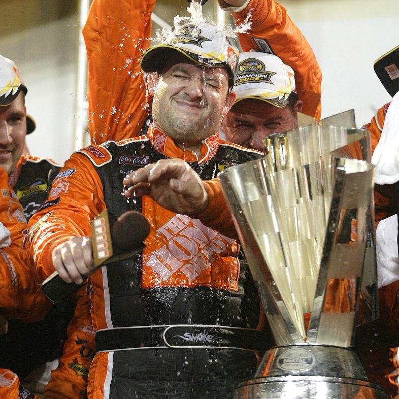 Tony Stewart celebrates winning the NASCAR Nextel championship after placing 15th in the Ford 400 race at the Homestead-Miami Speedway, in Homestead, Florida